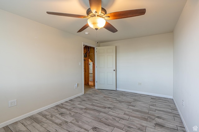 unfurnished room with baseboards, a ceiling fan, and light wood-style floors