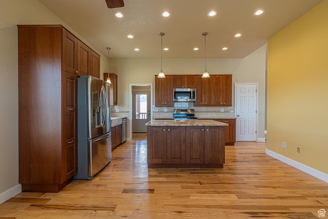 kitchen featuring recessed lighting, stainless steel appliances, backsplash, light wood-type flooring, and a kitchen island