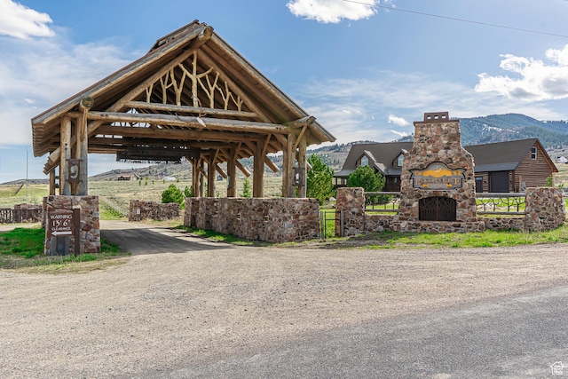 surrounding community with fence and dirt driveway