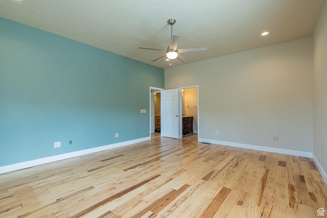 empty room with baseboards, a ceiling fan, light wood finished floors, and recessed lighting