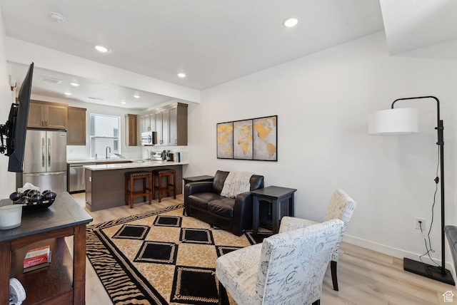 306 W Azure Sky Ln, Salt Lake City, UT 84103 - living area with light wood finished floors, baseboards, and recessed lighting