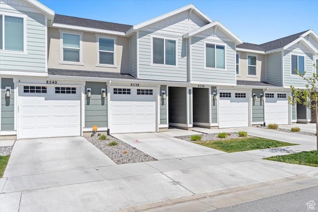 multi unit property with a garage and driveway