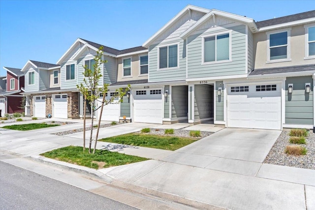 multi unit property with an attached garage and driveway