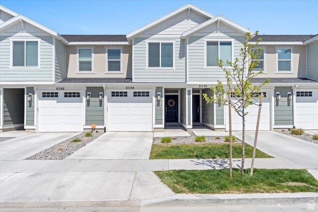 multi unit property featuring driveway and a garage