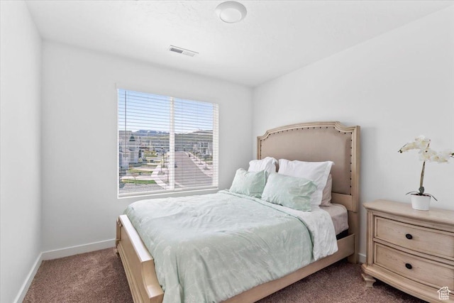 carpeted bedroom featuring baseboards and visible vents