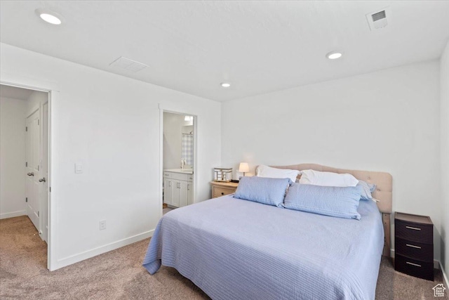 carpeted bedroom with connected bathroom, baseboards, visible vents, and recessed lighting