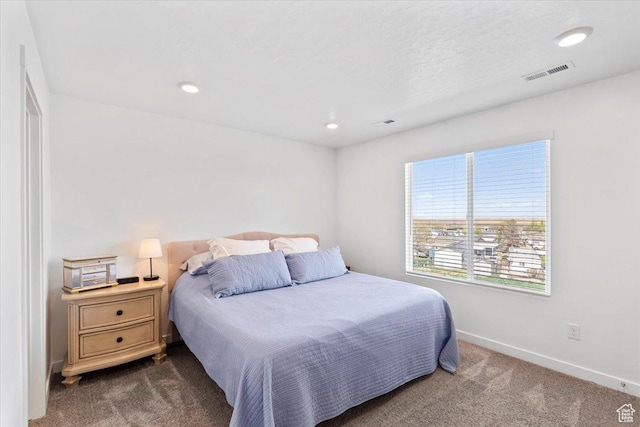 carpeted bedroom with baseboards, visible vents, and recessed lighting