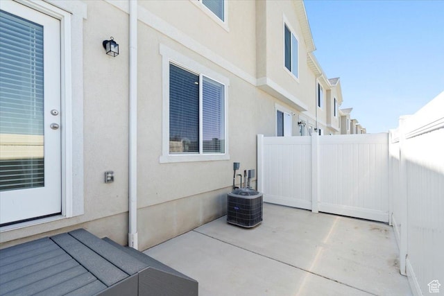 view of patio / terrace featuring central AC and fence
