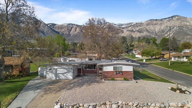 498 E 3000 N, North Ogden, UT 84414 - ranch-style house with brick siding, a mountain view, concrete driveway, and a garage