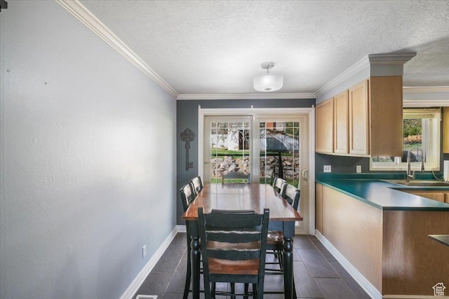 498 E 3000 N, North Ogden, UT 84414 - dining area featuring baseboards, crown molding, a textured ceiling, and dark tile patterned flooring