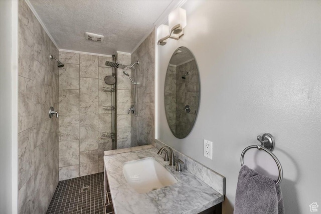 498 E 3000 N, North Ogden, UT 84414 - bathroom featuring a tile shower, vanity, a textured ceiling, and visible vents