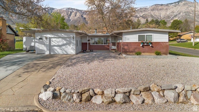 498 E 3000 N, North Ogden, UT 84414 - single story home with driveway, brick siding, a mountain view, and a garage
