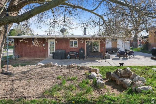 498 E 3000 N, North Ogden, UT 84414 - back of property with fence, a patio area, and brick siding
