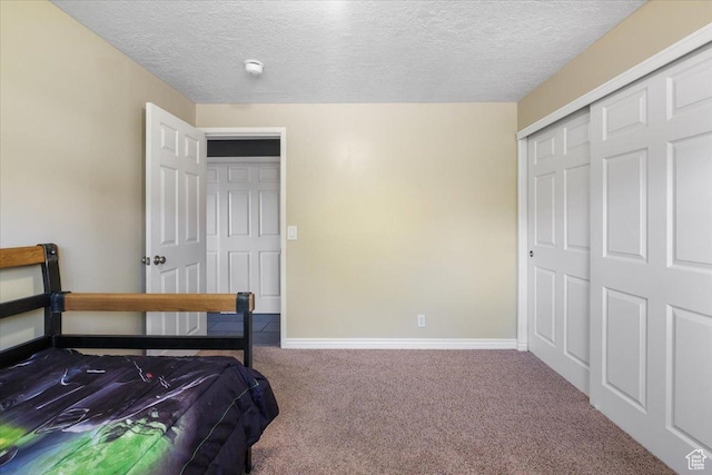 498 E 3000 N, North Ogden, UT 84414 - carpeted bedroom featuring a textured ceiling, a closet, and baseboards