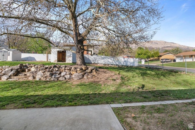 498 E 3000 N, North Ogden, UT 84414 - view of yard featuring an outdoor structure, a storage unit, fence, and a mountain view