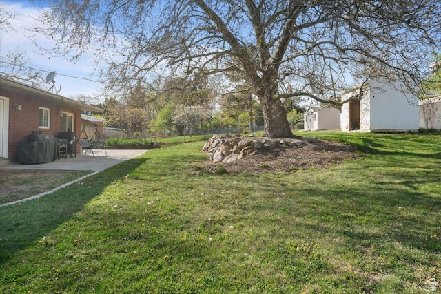 498 E 3000 N, North Ogden, UT 84414 - view of yard featuring fence, an outbuilding, and a patio area