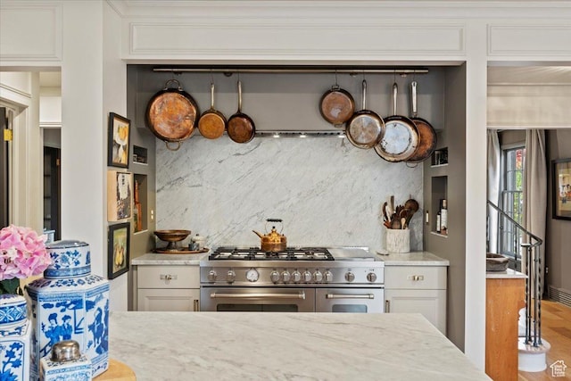 1904 E Yalecrest Ave S, Salt Lake City, UT 84108 - kitchen with white cabinets, tasteful backsplash, double oven range, wood finished floors, and light stone counters