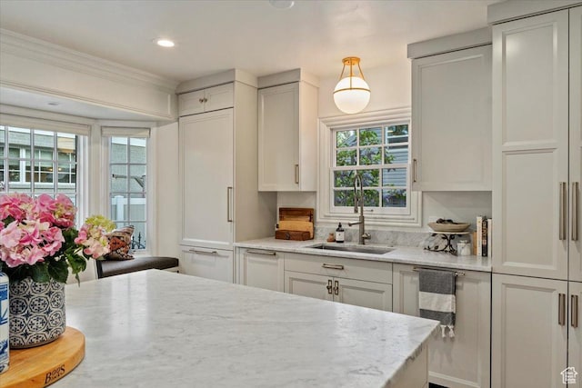 1904 E Yalecrest Ave S, Salt Lake City, UT 84108 - kitchen with white cabinets, a healthy amount of sunlight, and a sink