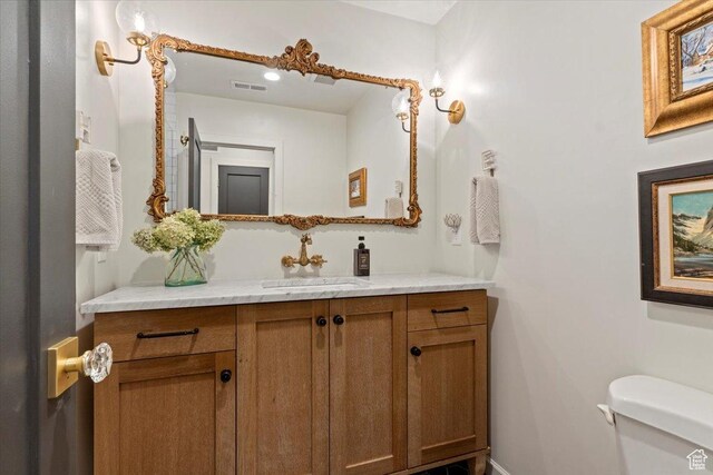 1904 E Yalecrest Ave S, Salt Lake City, UT 84108 - bathroom featuring baseboards, visible vents, toilet, and vanity