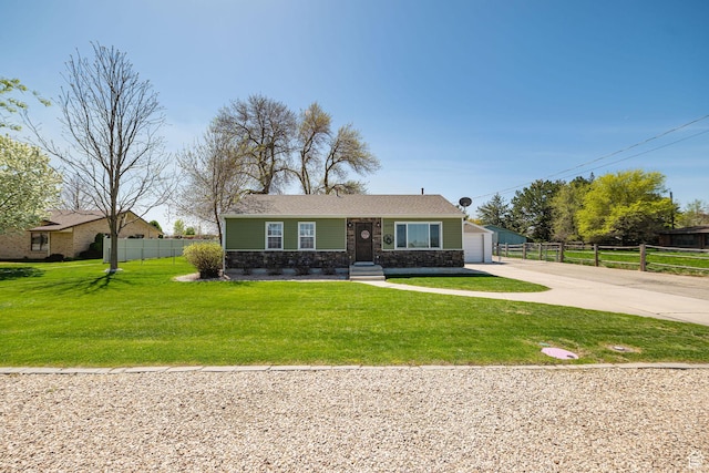 bungalow-style home featuring fence, a front lawn, concrete driveway, stone siding, and a garage
