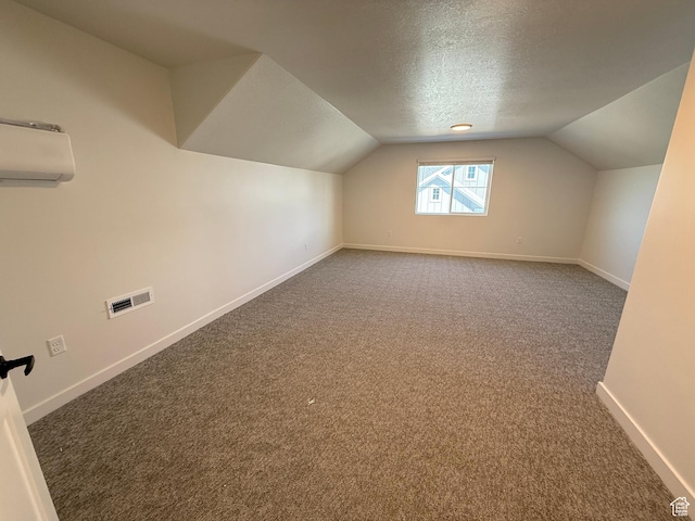 4 S 3830 W Unit 418, West Point, UT 84015 - bonus room featuring an AC wall unit, carpet, vaulted ceiling, a textured ceiling, and baseboards