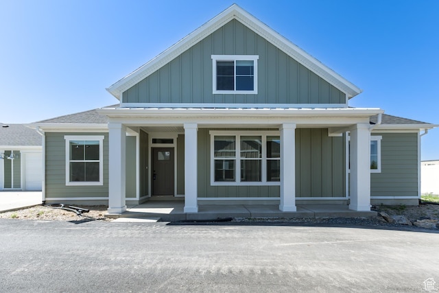 4 S 3830 W Unit 418, West Point, UT 84015 - view of front of house with covered porch, board and batten siding, and a shingled roof