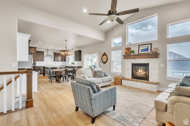 1153 E 2850 N, North Ogden, UT 84414 - living room featuring a fireplace, recessed lighting, light wood-style flooring, and ceiling fan with notable chandelier