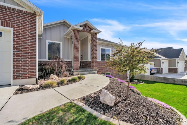 1153 E 2850 N, North Ogden, UT 84414 - view of front of home featuring board and batten siding, brick siding, and a front yard