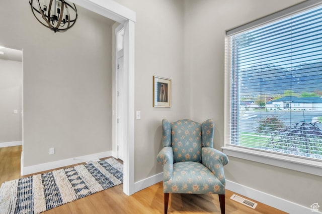 1153 E 2850 N, North Ogden, UT 84414 - living area featuring baseboards, a chandelier, wood finished floors, and visible vents