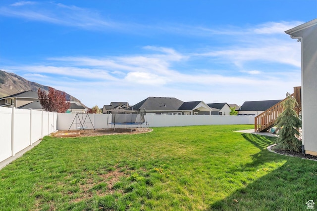 1153 E 2850 N, North Ogden, UT 84414 - view of yard with a fenced backyard, a residential view, and a trampoline