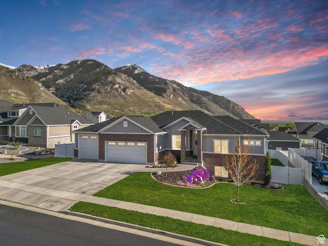 ranch-style home featuring a gate, concrete driveway, fence, a garage, and board and batten siding