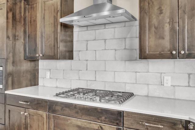 1153 E 2850 N, North Ogden, UT 84414 - kitchen with wall chimney exhaust hood, stainless steel gas cooktop, dark brown cabinetry, backsplash, and light countertops