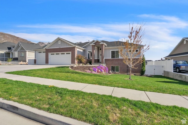 1153 E 2850 N, North Ogden, UT 84414 - ranch-style house with fence, concrete driveway, an attached garage, brick siding, and a front yard