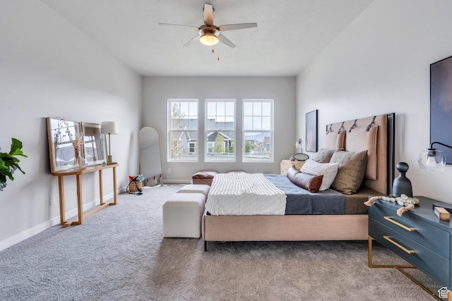 carpeted bedroom with a ceiling fan and baseboards