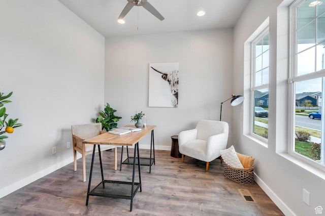 office area featuring baseboards, wood finished floors, visible vents, and a healthy amount of sunlight