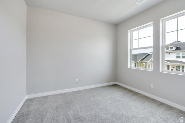 carpeted spare room with baseboards