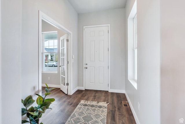 foyer with visible vents, baseboards, and wood finished floors
