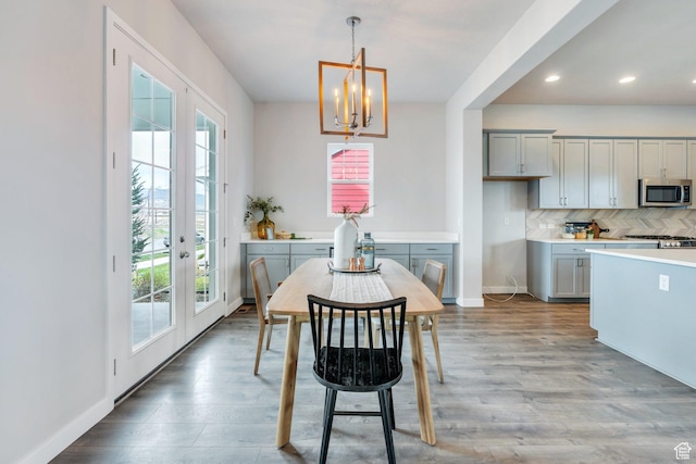 dining room featuring an inviting chandelier, baseboards, a wealth of natural light, and recessed lighting