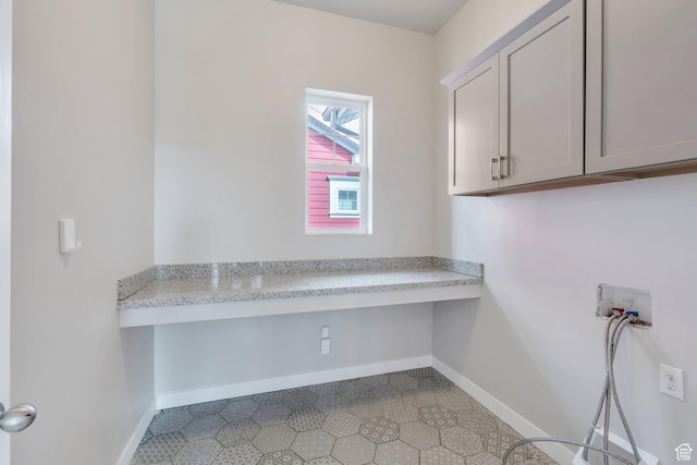laundry room featuring baseboards, cabinet space, and hookup for a washing machine