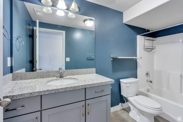 full bathroom with tile patterned floors, toilet, vanity, tub / shower combination, and baseboards
