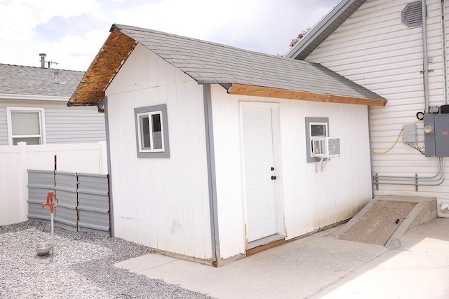 view of outdoor structure featuring an outbuilding and fence