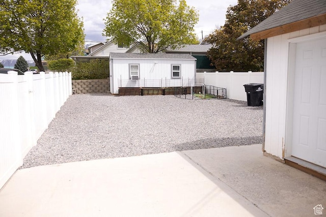 view of patio / terrace with a fenced backyard, an outbuilding, and cooling unit