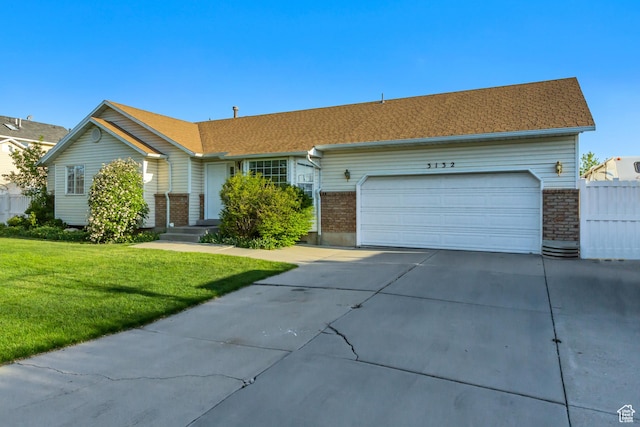 single story home with an attached garage, brick siding, driveway, and a front yard