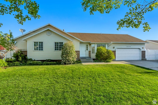 ranch-style house featuring an attached garage, driveway, brick siding, and a front yard