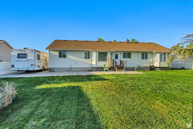back of property featuring a yard