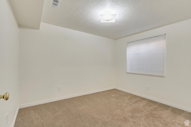 unfurnished room featuring baseboards, carpet flooring, and a textured ceiling