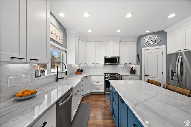 322 Flour Mill Dr, Kaysville, UT 84037 - kitchen with blue cabinetry, appliances with stainless steel finishes, a sink, and white cabinets
