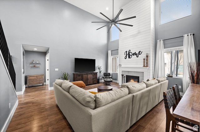 322 Flour Mill Dr, Kaysville, UT 84037 - living area featuring ceiling fan, a high ceiling, a tile fireplace, and dark wood-type flooring