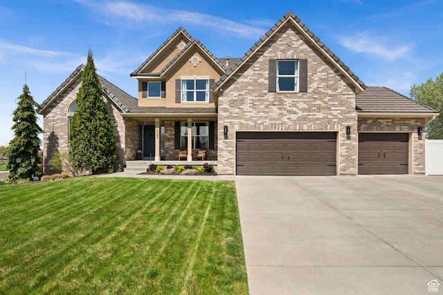 322 Flour Mill Dr, Kaysville, UT 84037 - craftsman-style house with a tiled roof, a front lawn, a porch, concrete driveway, and brick siding