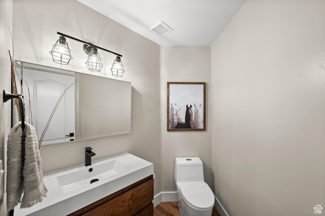 322 Flour Mill Dr, Kaysville, UT 84037 - half bathroom with toilet, baseboards, visible vents, wood finished floors, and vanity